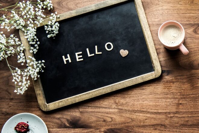 Black chalkboard with the word hello and a pink heart